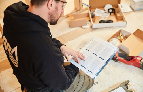 guy reading moen parts manual